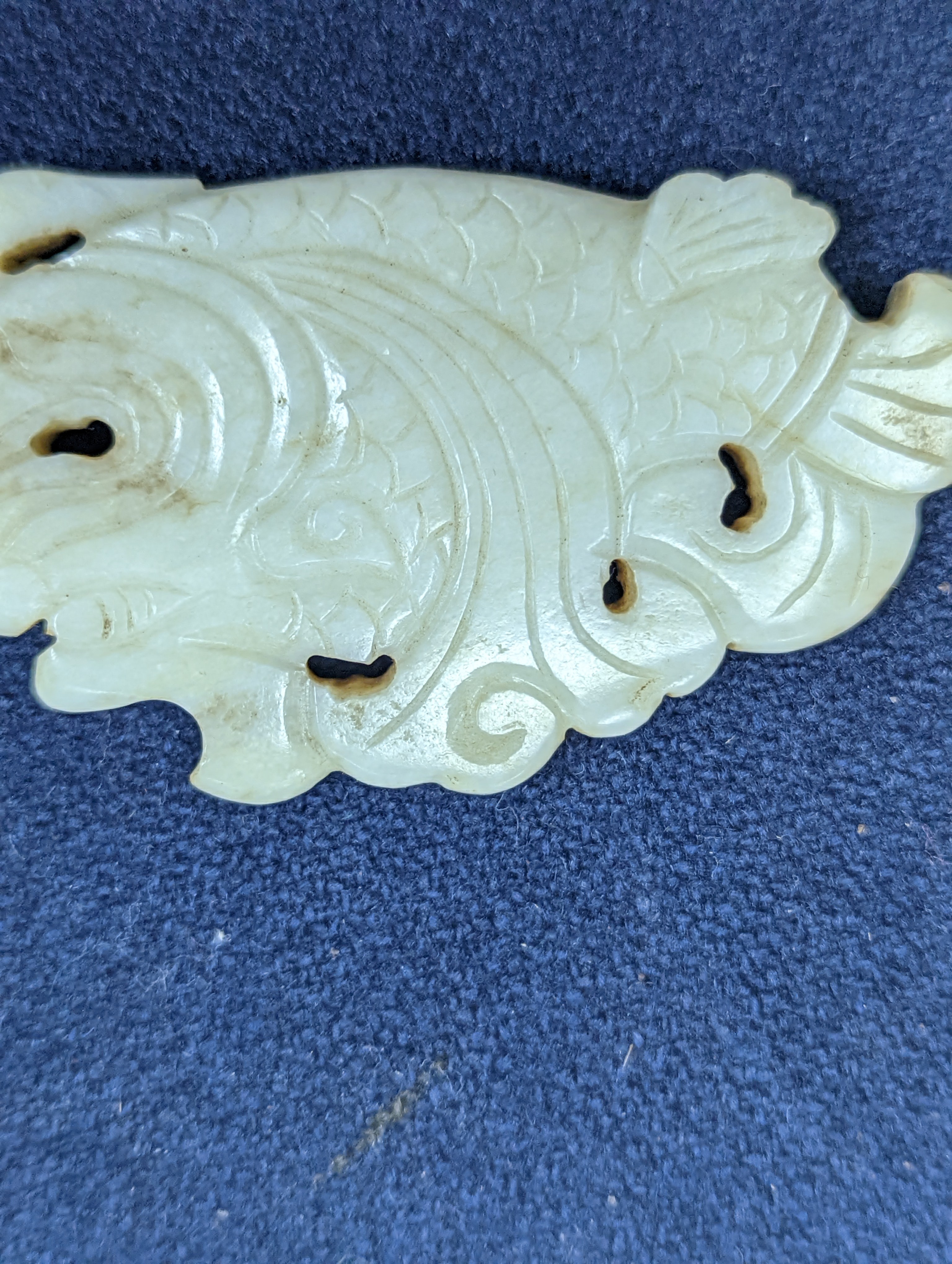 A Chinese white and black jade ‘dragon-fish’ plaque, 19th/20th century, 6cm